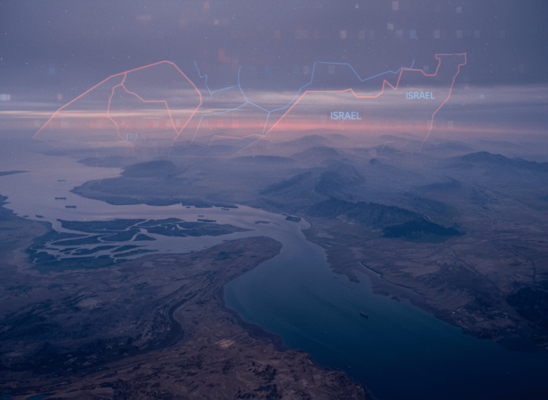 An aerial view of a strait with a map overlay showing lines for Iran and Israel, signifying geopolitical tension.